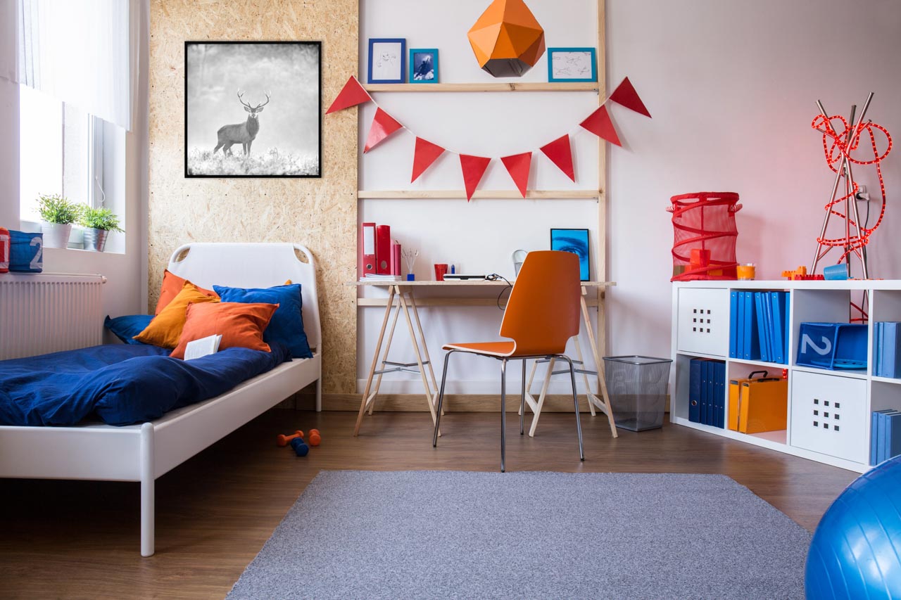 A fine art print in black and white displayed on a wall of a bedroom of a boy.