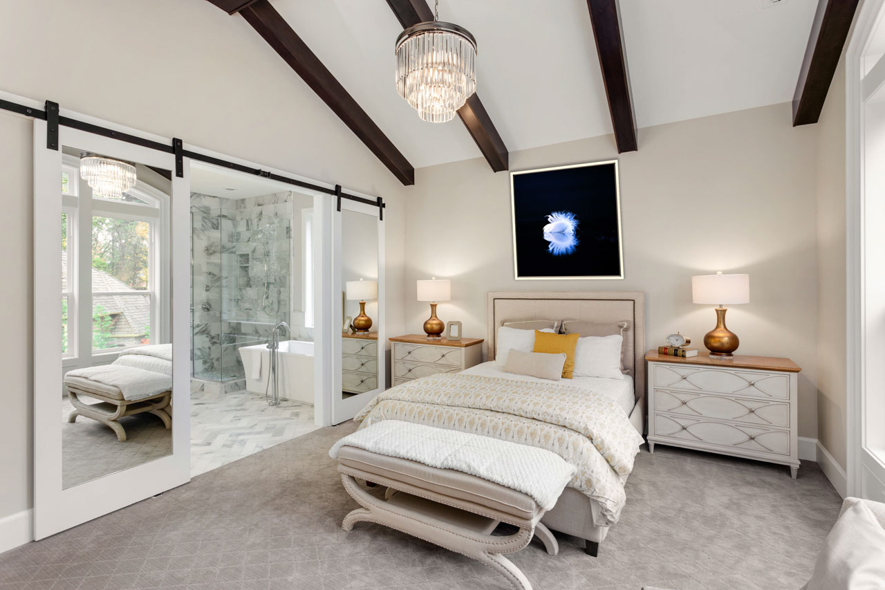 A fine art print displayed on a wall of a master bedroom.