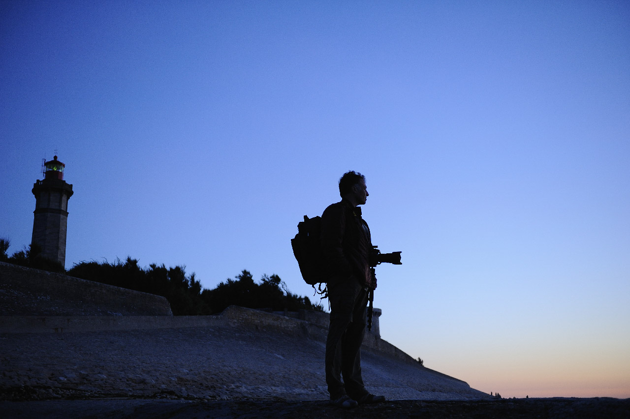 A photographer lost in thought contemplating a landscape in Charente-Maritime.