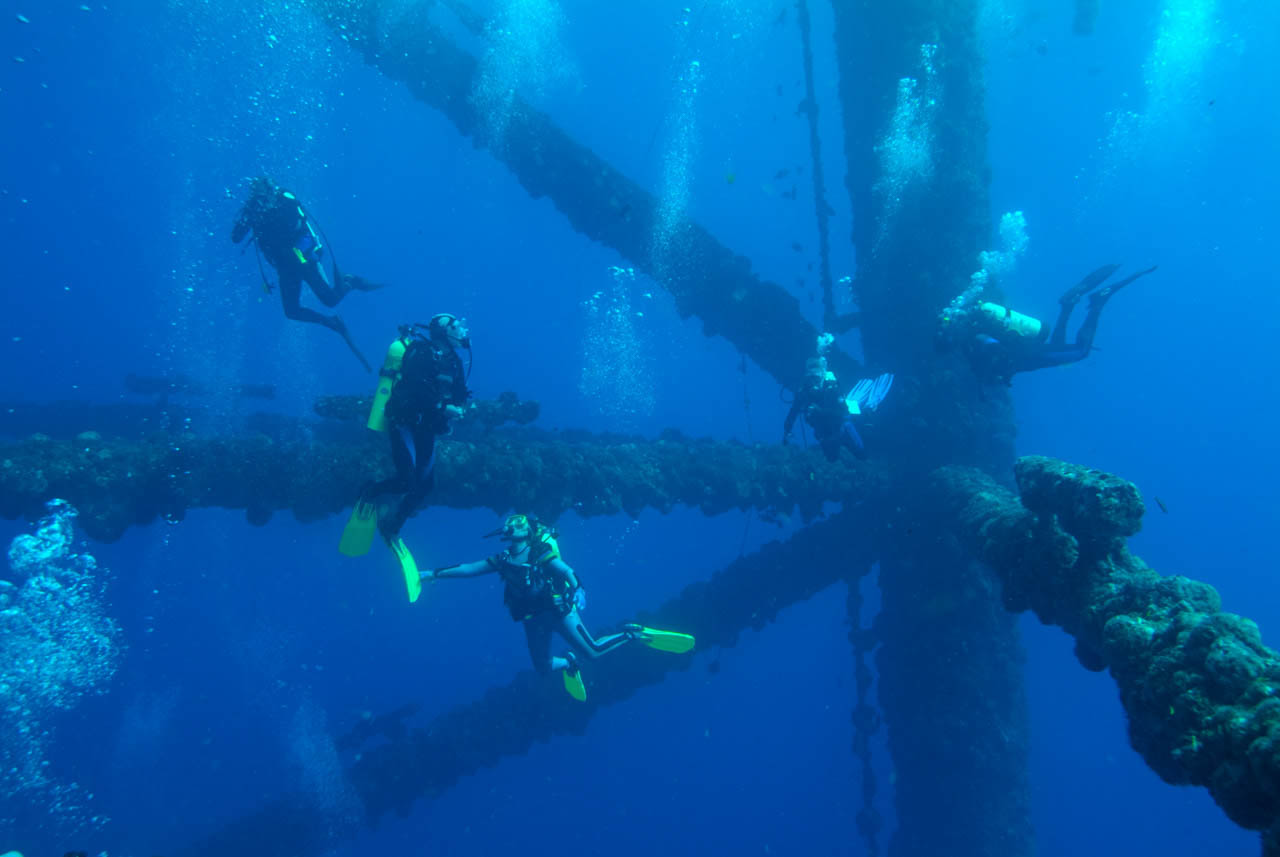 Scuba divers around an oil rig in the Gulf of Mexico off Texas coast.