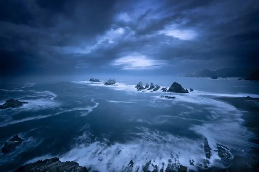 Seascape of the Asturias in Spain. The waves are breaking on the cliffs or the rocks of the coast.