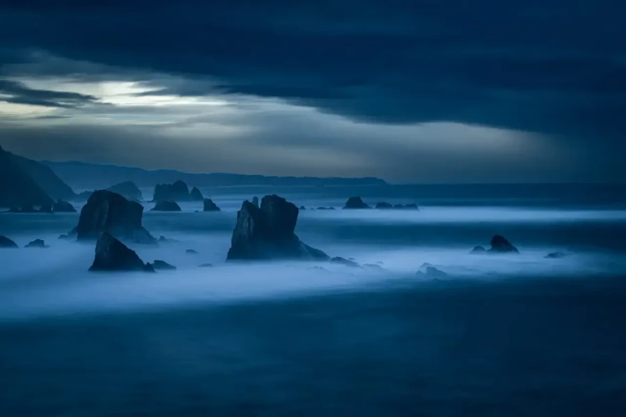 Seascape of the Asturias in Spain. The waves are breaking on the cliffs or the rocks of the coast.