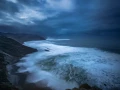 Seascape of the Asturias in Spain. The waves are breaking on the cliffs or the rocks of the coast.