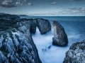 Seascape of the Asturias in Spain. The waves are breaking on the cliffs or the rocks of the coast.