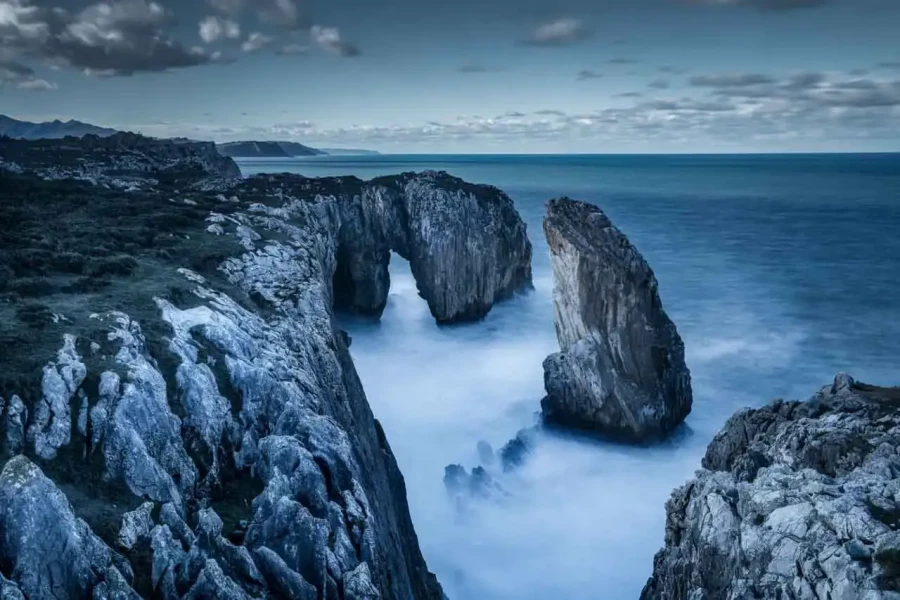 Seascape of the Asturias in Spain. The waves are breaking on the cliffs or the rocks of the coast.