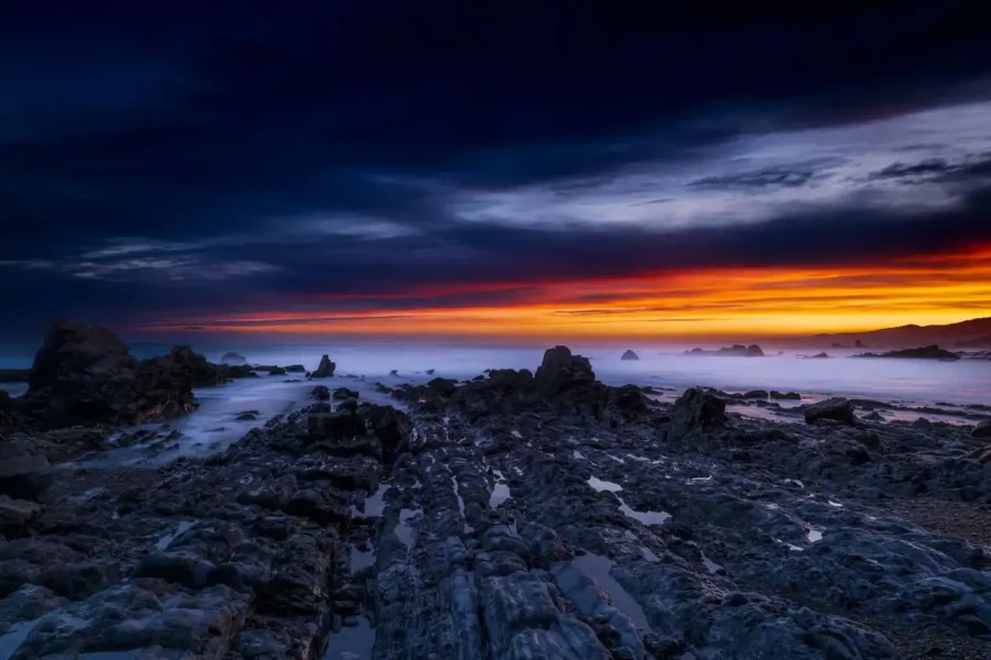 Seascape of the Asturias in Spain. The waves are breaking on the cliffs or the rocks of the coast.