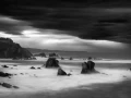 Seascape of Asturias in Spain in black and white.The waves of the Atlantic Oceans break on the rocks of the shore or on the cliffs.