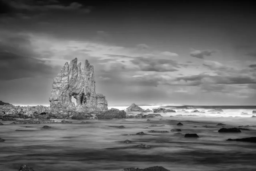 Seascape of Asturias in Spain in black and white.The waves of the Atlantic Oceans break on the rocks of the shore or on the cliffs.