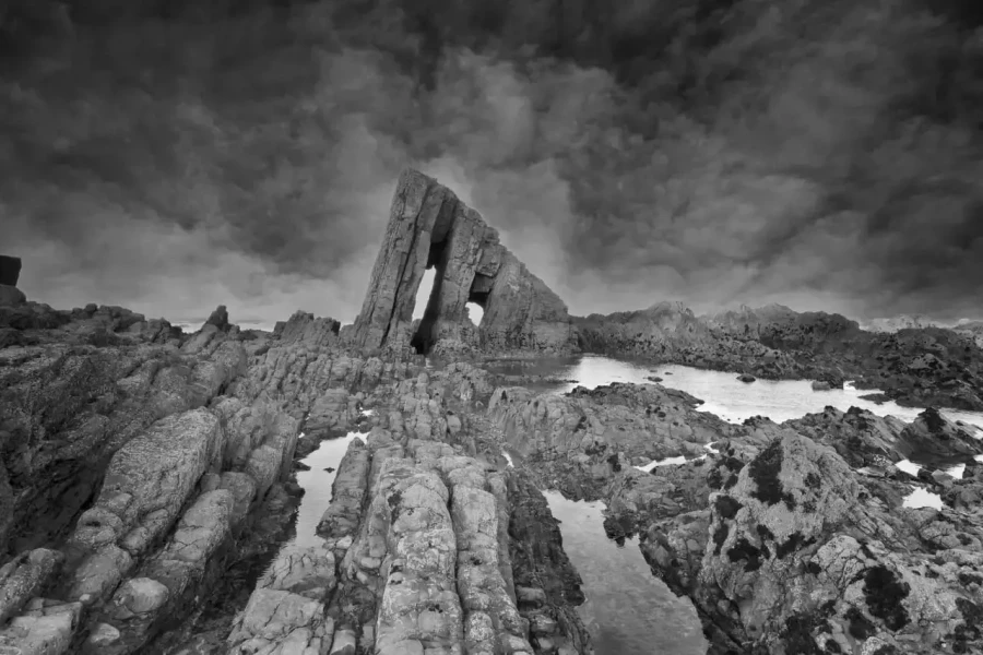Seascape of Asturias in Spain in black and white.The waves of the Atlantic Oceans break on the rocks of the shore or on the cliffs.