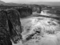 Seascape of Asturias in Spain in black and white.The waves of the Atlantic Oceans break on the rocks of the shore or on the cliffs.