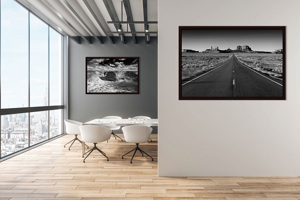 Two fine art prints in black and white displayed in a meeting room of a tech company.