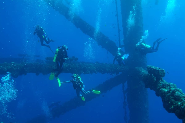 Scuba divers around an oil rig in the Gulf of Mexico off Texas coast.